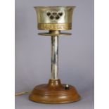A 1948 LONDON OLYMPIC TORCH converted to a table lamp, & mounted on an oak circular plinth base,