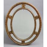 A gilt frame oval wall mirror with a mirrored border, 28½” x 36”.
