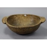 A vintage wooden large dough bowl, with plain side handles, 29½” x 23”; a wicker basket; & a