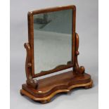 A late 19th century mahogany rectangular swing toilet glass, with scroll-shaped end supports & on