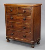 A late Victorian mahogany small chest fitted two short & three long graduated drawers with turned