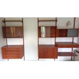 A PS system teak inter-changeable wall unit fitted with numerous drawers, cupboards, & shelves.