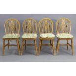 A set of four beech Windsor-style wheel-back dining chairs with hard seats, on turned legs; & a pine