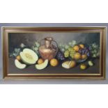 A large still-life study of fruit with a vase, signed “Rodriguez”, Oil on Canvas: 23” x 50”, in gilt