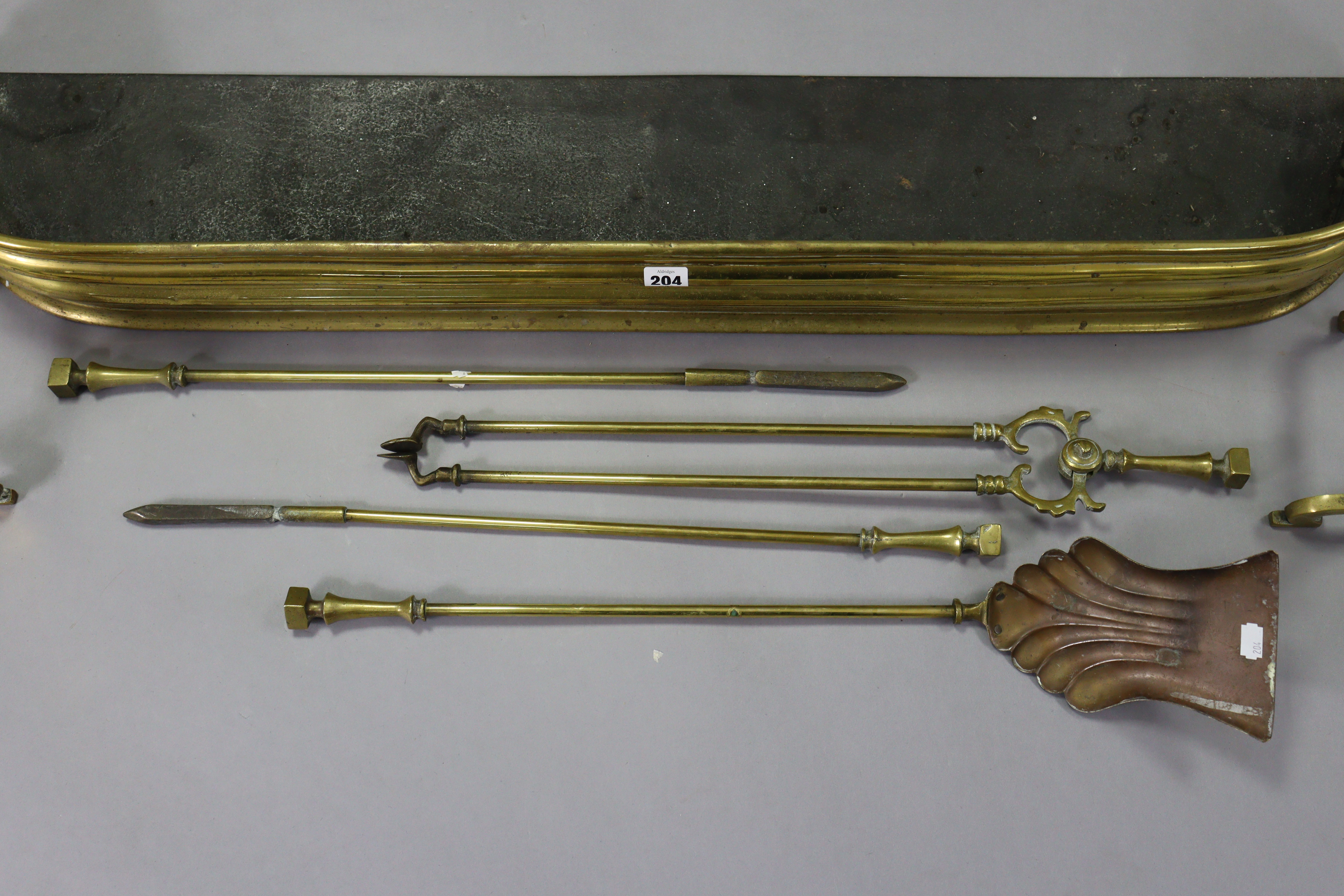 A brass fender, 45” long; together with a pair of brass fire dogs; & a set of four brass fire - Image 2 of 3