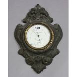 An early 20th century wall barometer, the 4¼” white enamel dial signed “T. DOWNIE, HAMBURG”, in