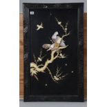 A Japanese black lacquered panel with mother-of-pearl inlaid decoration of birds amongst foliage, in