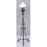 A black painted wrought-iron standard lamp on triform supports, 58” high.