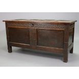 A late 17th century oak coffer, with hinged lift-lid, carved frieze & a two-panel front (