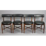 A set of four G-Plan teak dining chairs with padded backs & circular seats, on round tapered legs