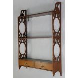 A set of George III style mahogany wall shelves with pierced fretwork sides & fitted two small