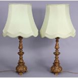 A pair of gilt composition table lamps, 31½” high, with shades.