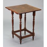 An oak occasional table with carved grapevine decoration to the square top, on four slender turned