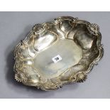 A Peruvian sterling large oval dish with raised lobed sides & scroll rim, 14¼” x 11¼” (16oz).