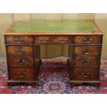 A 19th century mahogany pedestal desk inset gilt-tooled leather surface, fitted an arrangement of