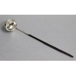 An 18th century punch ladle, the circular bowl fashioned from a silver coin, the centre inset