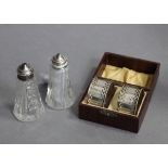 A pair of silver napkin rings; & a pair of silver-topped cut glass salt & pepper pots.