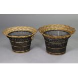 A pair of black & gilt painted wicker waste paper baskets of flared form, each 15” wide x 10” high.