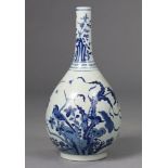 AN EARLY 18th century CHINESE BLUE & WHITE PORCELAIN BOTTLE VASE, decorated with foliage, birds &