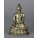 An oriental white metal figure of a Buddhistic deity, seated on double lotus base, 6” high.