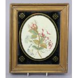 An early 19th century silk embroidered picture of a floral spray, in oval verre eglomise mount &
