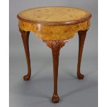 An early 20th century burr maple veneered circular occasional table with shaped frieze, on slender
