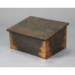 An early 20th century rectangular wooden slipper box clad in embossed copper with sloping hinged