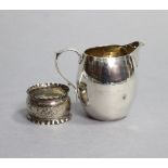 A plain silver barrel-shaped cream jug with scroll handle, 3”, London 1929 (2.8oz); & a silver
