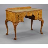 An early 20th century burr maple veneered writing table, inset tooled tan leather top, fitted with