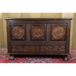 AN 18th CENTURY OAK MULE CHEST, the three-panel front profusely carved with stylised decoration &