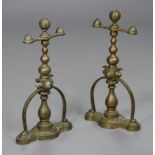 A pair of 19th century brass andirons with blauster columns on shaped rectangular platform bases,