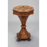 A Victorian inlaid mahogany needlework table of octagonal form, the fitted interior enclosed by