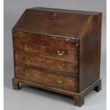An early 18th century oak bureau with fitted interior & well compartment enclosed by a sloping
