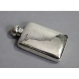 An Edwardian silver pocket spirit flask with hinged ball screw cap, 5¼” high; London 1905 by W. & G.