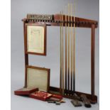 A COLLECTION OF EARLY 20thC SNOOKER & BILLIARDS ACCESSORIES, to include a mahogany cue-rack, 56”