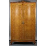 AN EARLY 20thC 13-PIECE BURR MAPLE VENEERED BEDROOM SUITE, comprising a three-door wardrobe; a two-