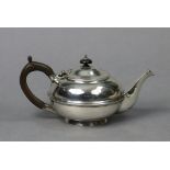 A George V silver teapot of squat round form with central moulded band, domed hinged lid, boxwood
