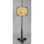 A William IV rosewood pole screen with gilt metal mounts, the rectangular rise-&-fall banner inset