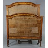 An Edwardian inlaid-walnut caned headboard & footboard with foliate decoration & on turned supports,