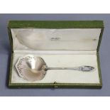 A late 19th/early 20th century French .950 standard serving spoon, the wide shaped round parcel-gilt
