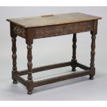 A 17th century style oak rectangular table with carved frieze & overhang top on turned supports,