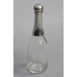 A LATE VICTORIAN SILVER-MOUNTED GLASS NOVELTY DECANTER, in the form of a champagne bottle, with