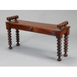 An early Victorian mahogany small hall bench with turned bolster ends to the hard seat, on bobbin-