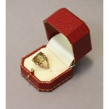 An 18K ring set pale green rectangular-cut gem with engraved intaglio depicting a rose-bud, & with