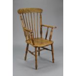 A late Victorian ash & elm lath-back elbow chair with spindle back, open arms & hard seat, on turned