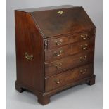 A Georgian mahogany bureau with a fitted interior enclosed by a fall-front above four long graduated