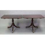 A regency-style mahogany twin-pedestal dining table with rounded corners to the rectangular top,