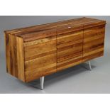 A teak sideboard (purchased from Silcox Son & Wicks) fitted three long drawers to centre flanked