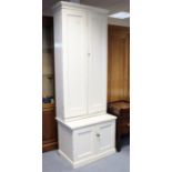 An early 20th century white painted pine tall cupboard the upper part fitted five shelves enclosed