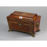 A 19th century brass-inlaid rosewood tea caddy with a fitted interior enclosed by a hinged lid, with